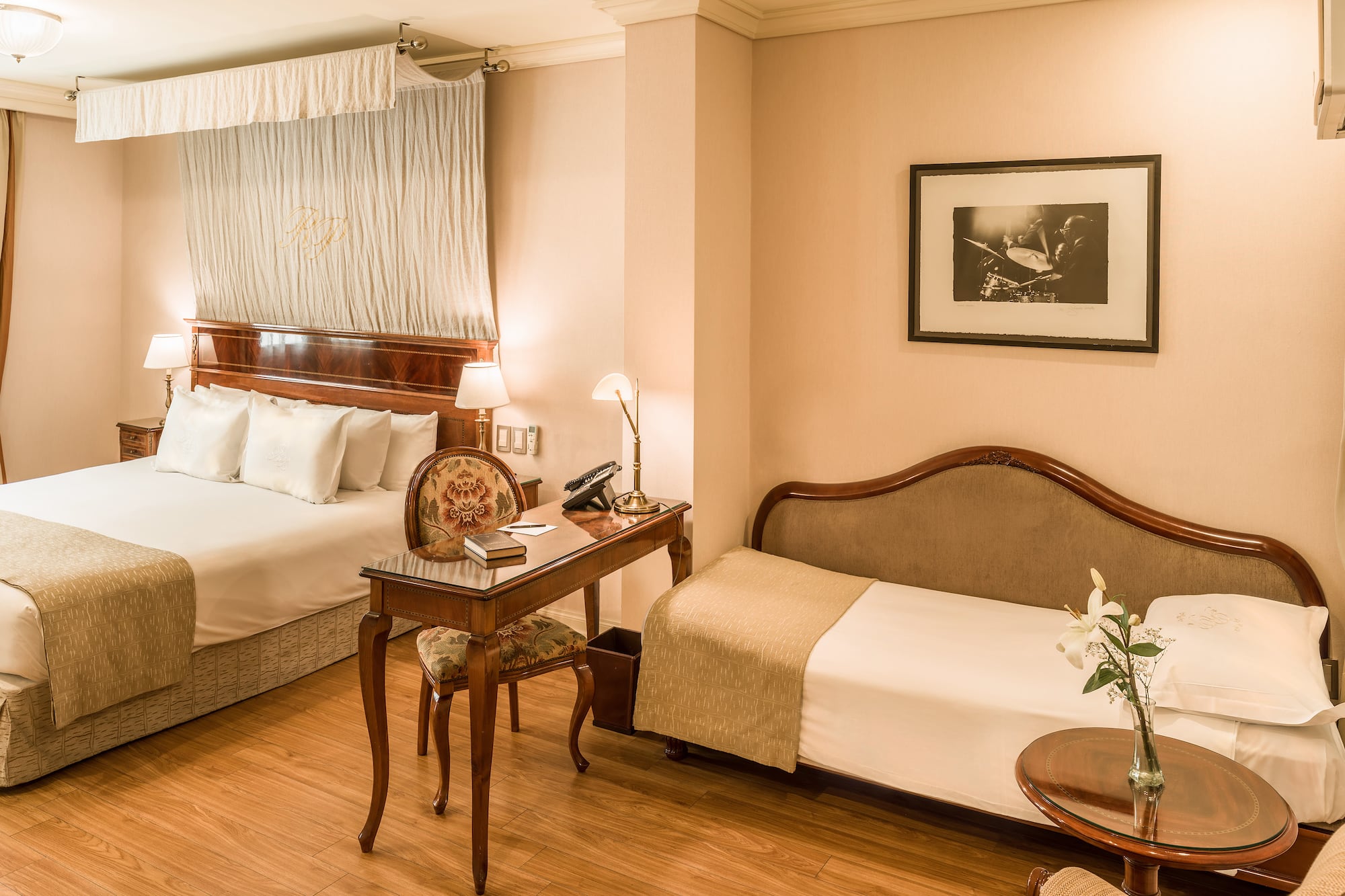 a room with two beds and a desk