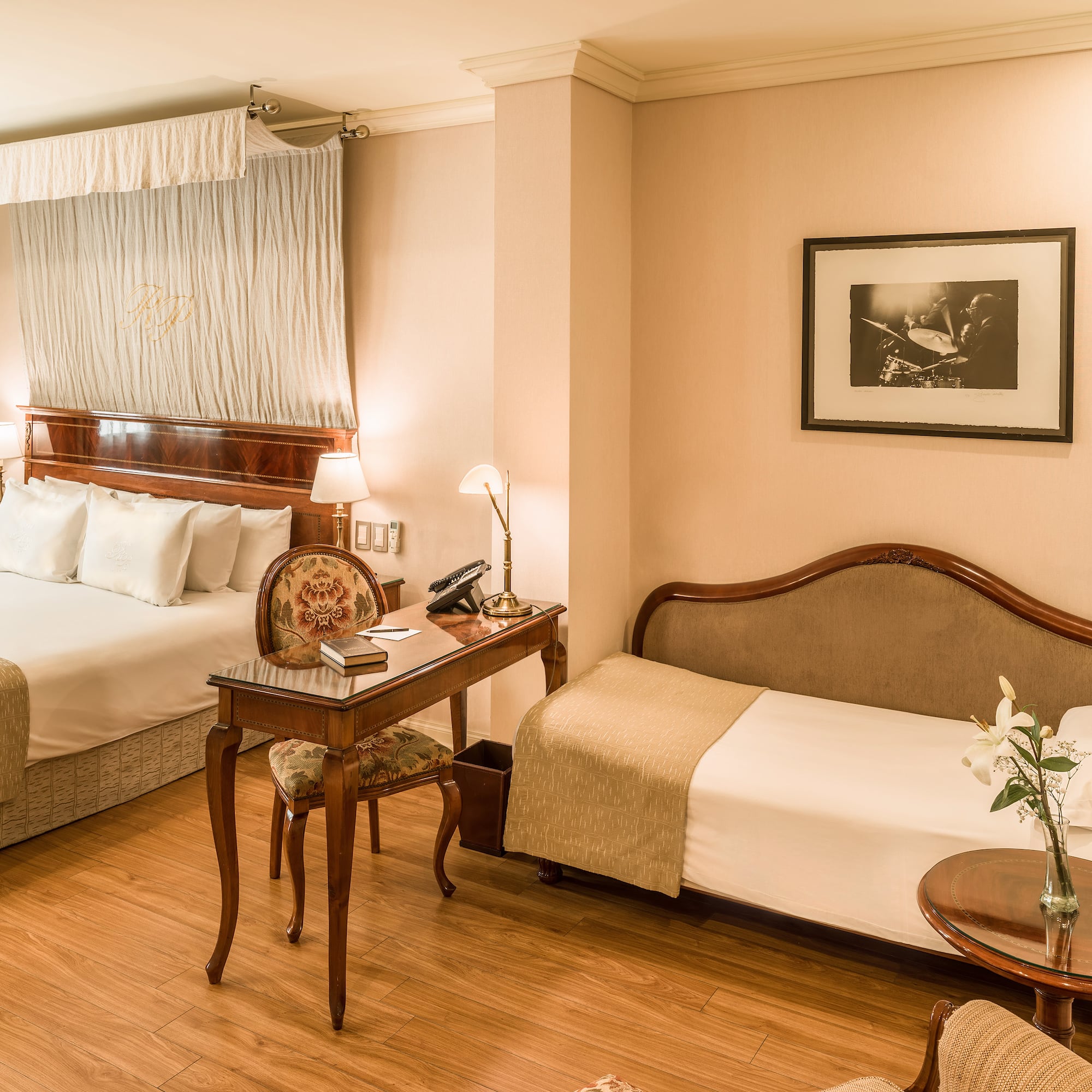 a room with two beds and a desk