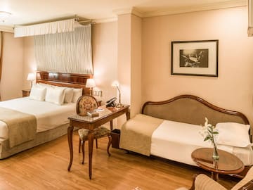 a room with two beds and a desk