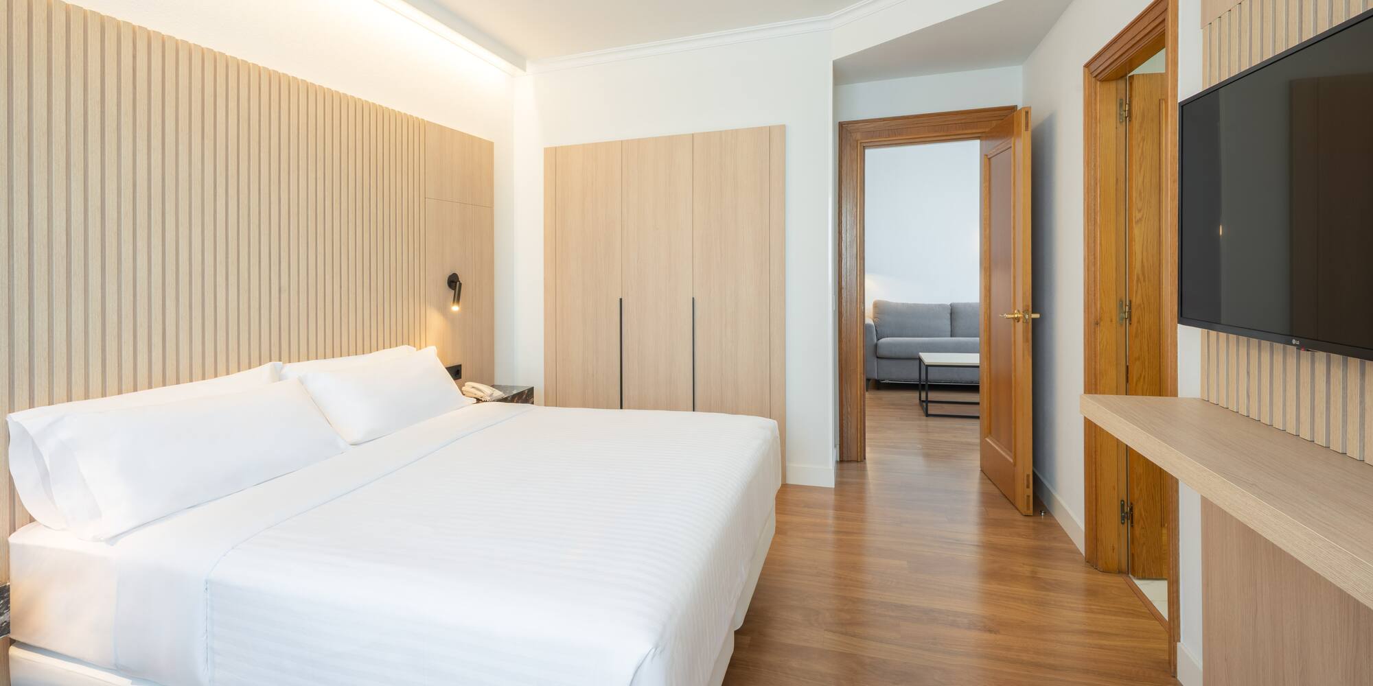 a bedroom with a bed and a wood floor