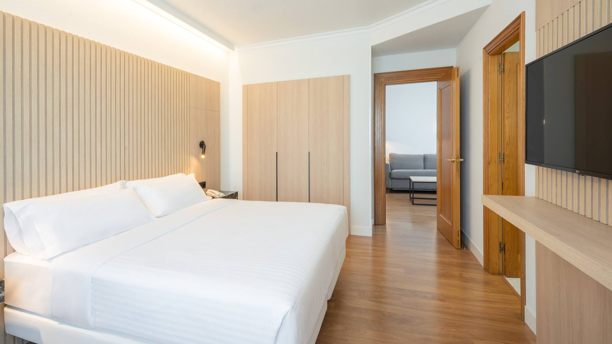 a bedroom with a bed and a wood floor