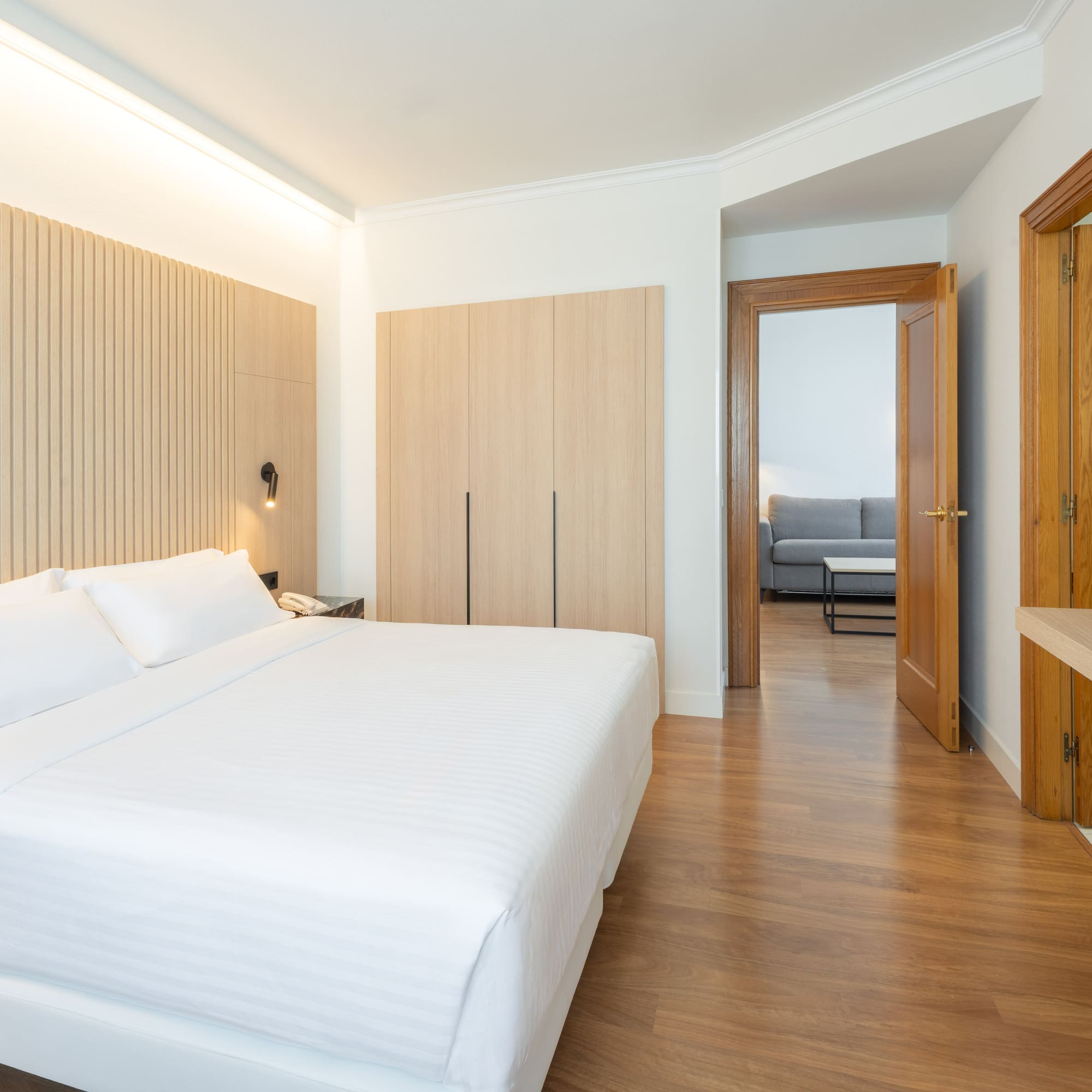 a bedroom with a bed and a wood floor