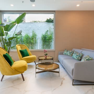 a room with a couch and a yellow chair