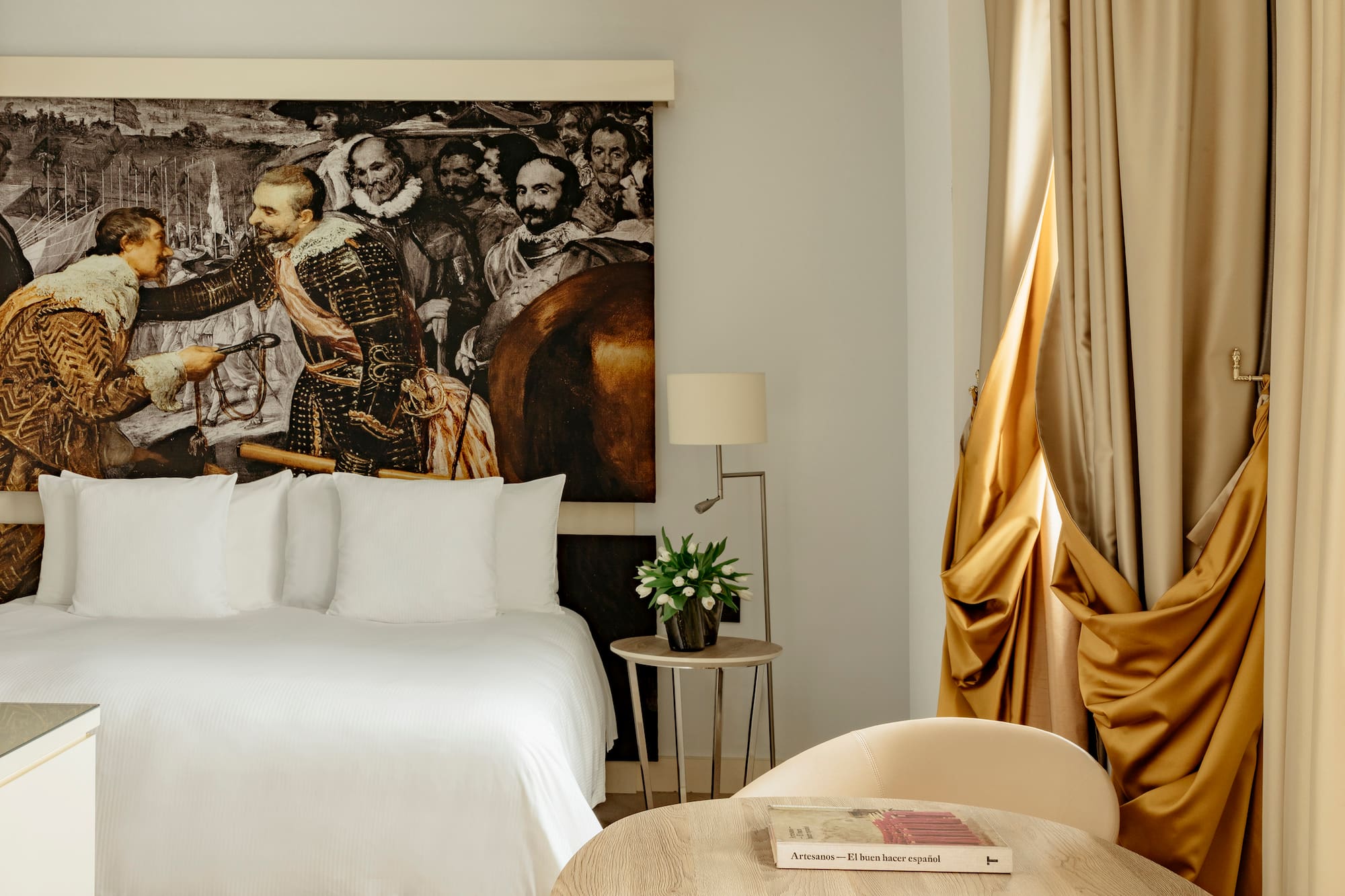 a room with a bed and a painting on the wall