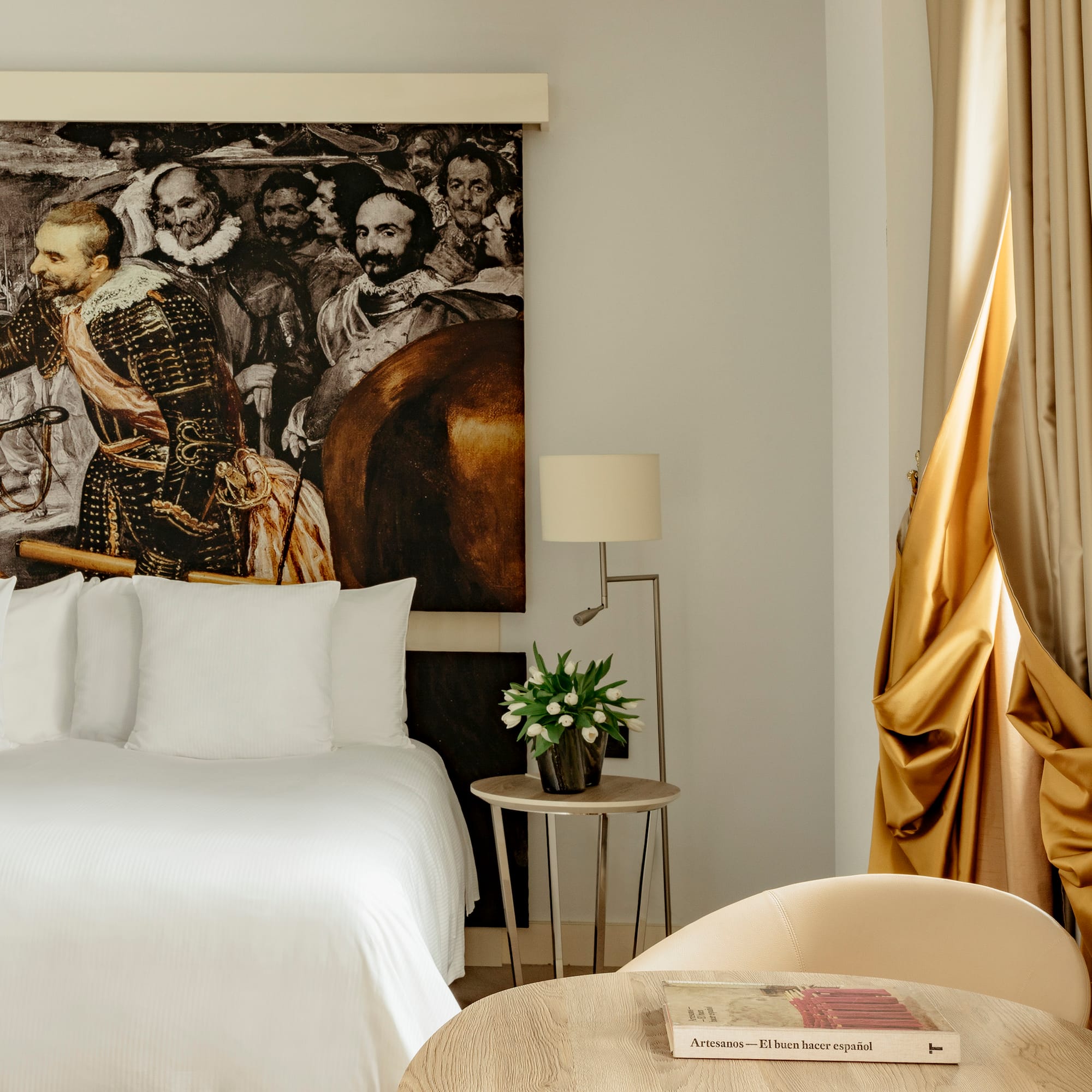 a room with a bed and a painting on the wall