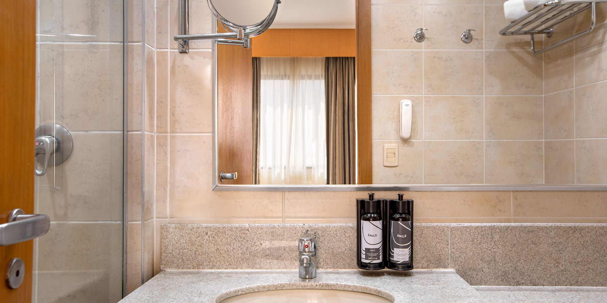 a bathroom with a mirror and a sink