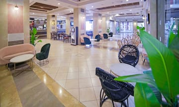 a large lobby with chairs and tables