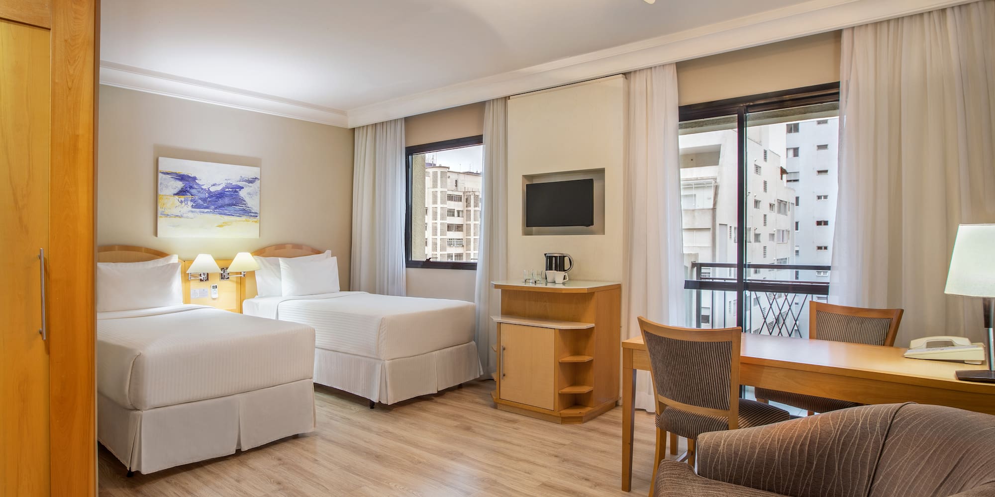 a room with two beds and a table