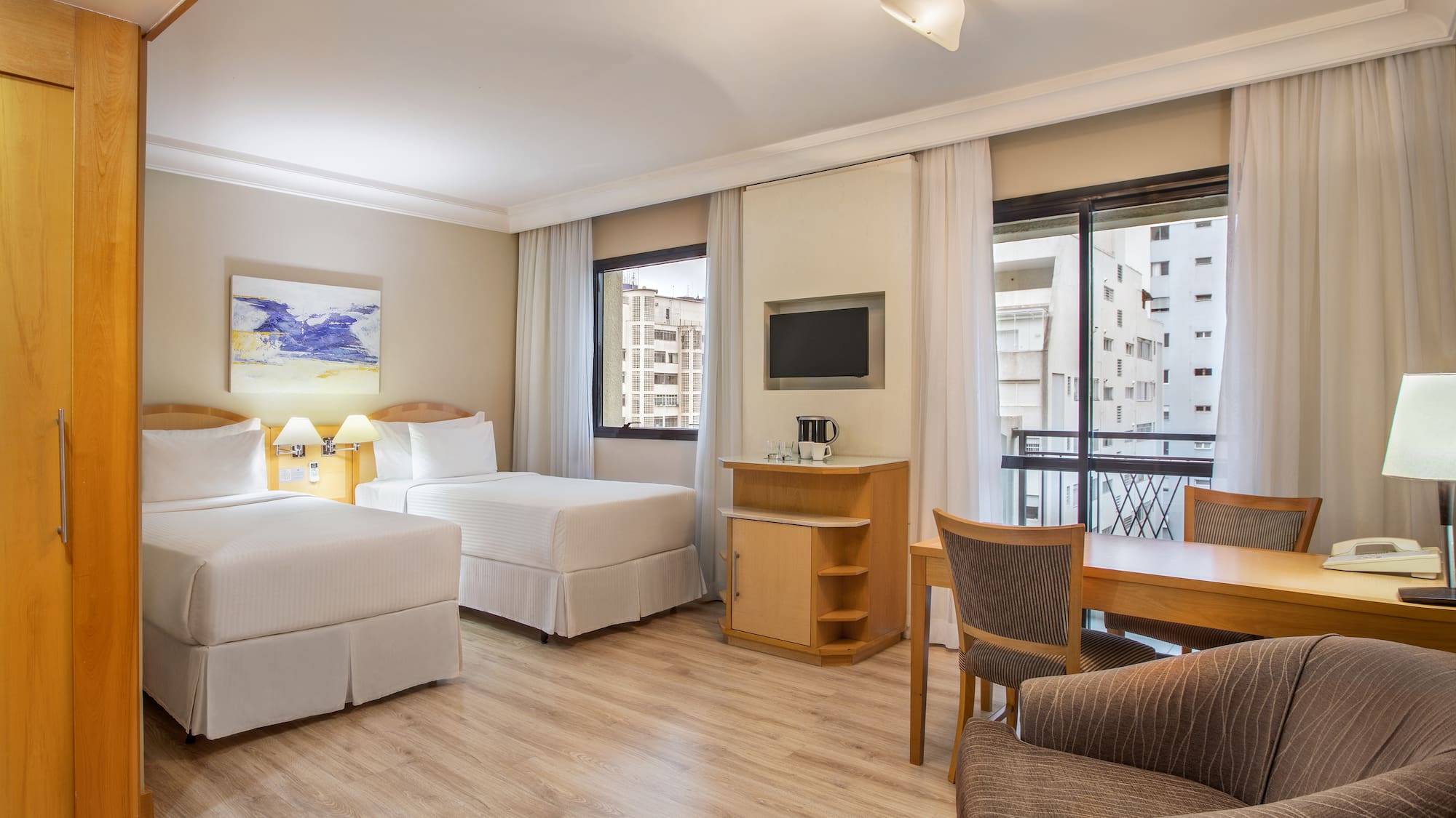 a room with two beds and a table