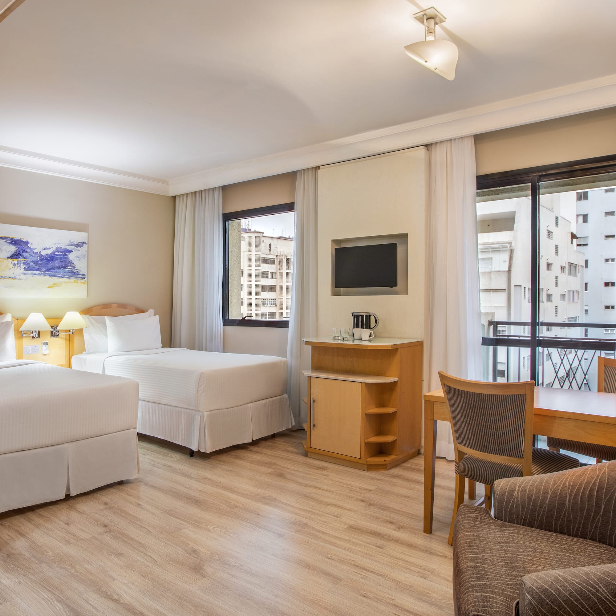 a room with two beds and a table