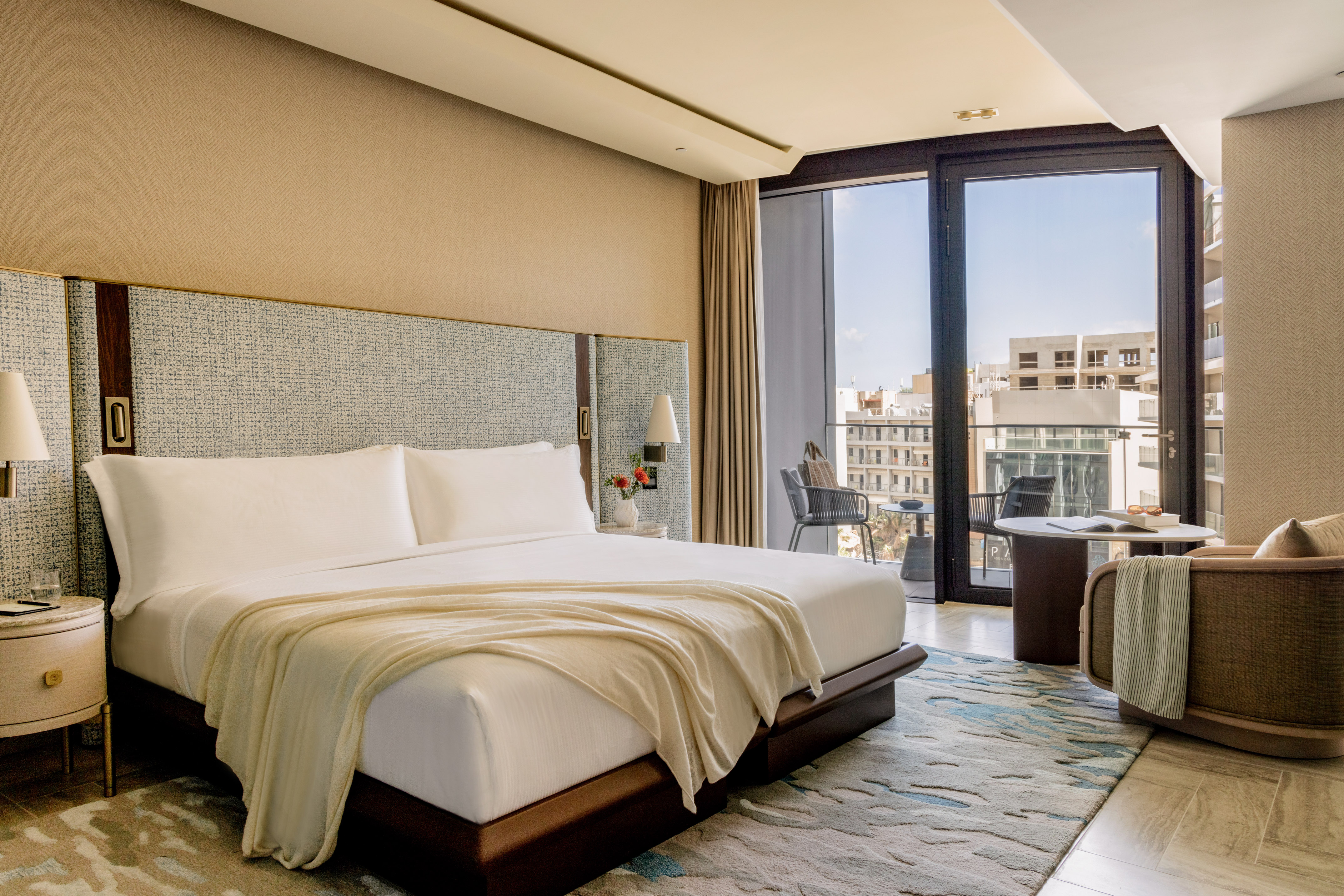 a bedroom with a large bed and a large window