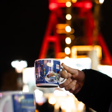 a person holding a mug