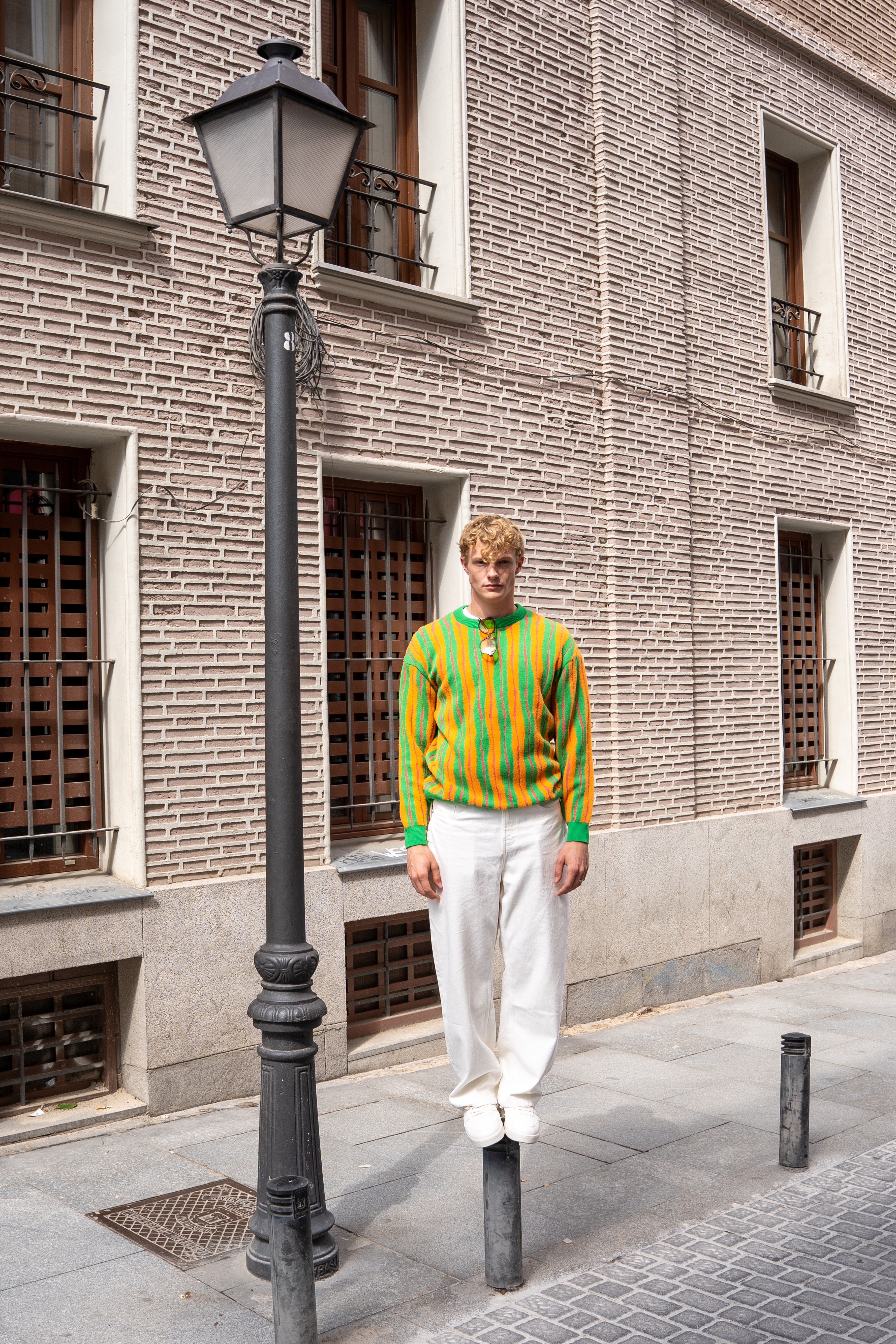a man standing on a street lamp