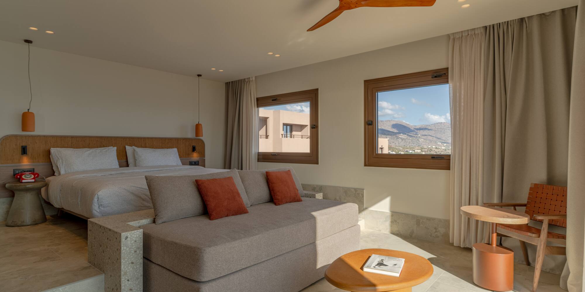 a room with a bed and a ceiling fan