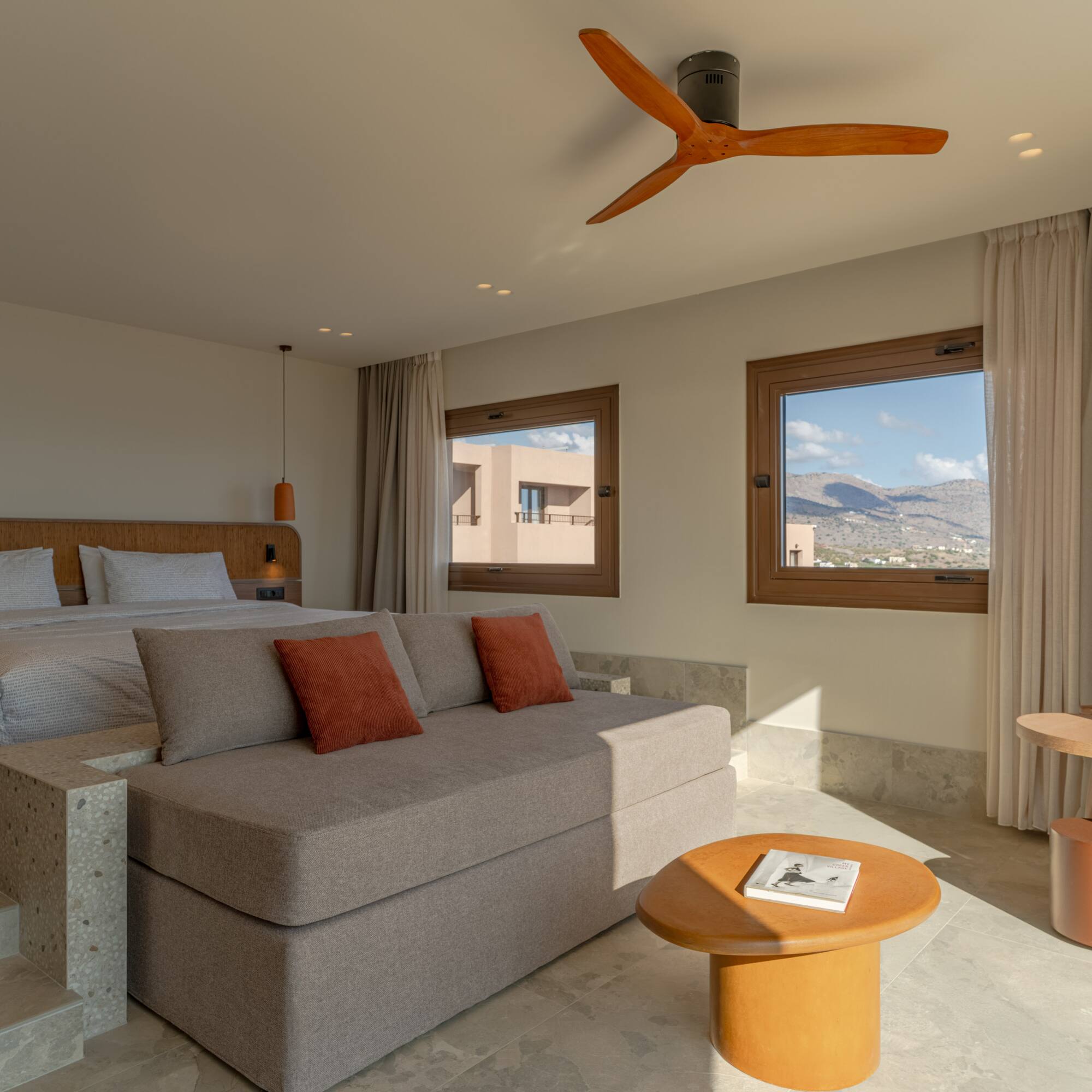 a room with a bed and a ceiling fan