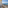 Balcony overlooking blue ocean, beach, and coastal road.