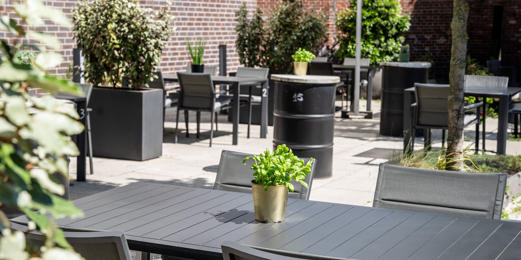 a table and chairs outside with a brick wall and a brick wall