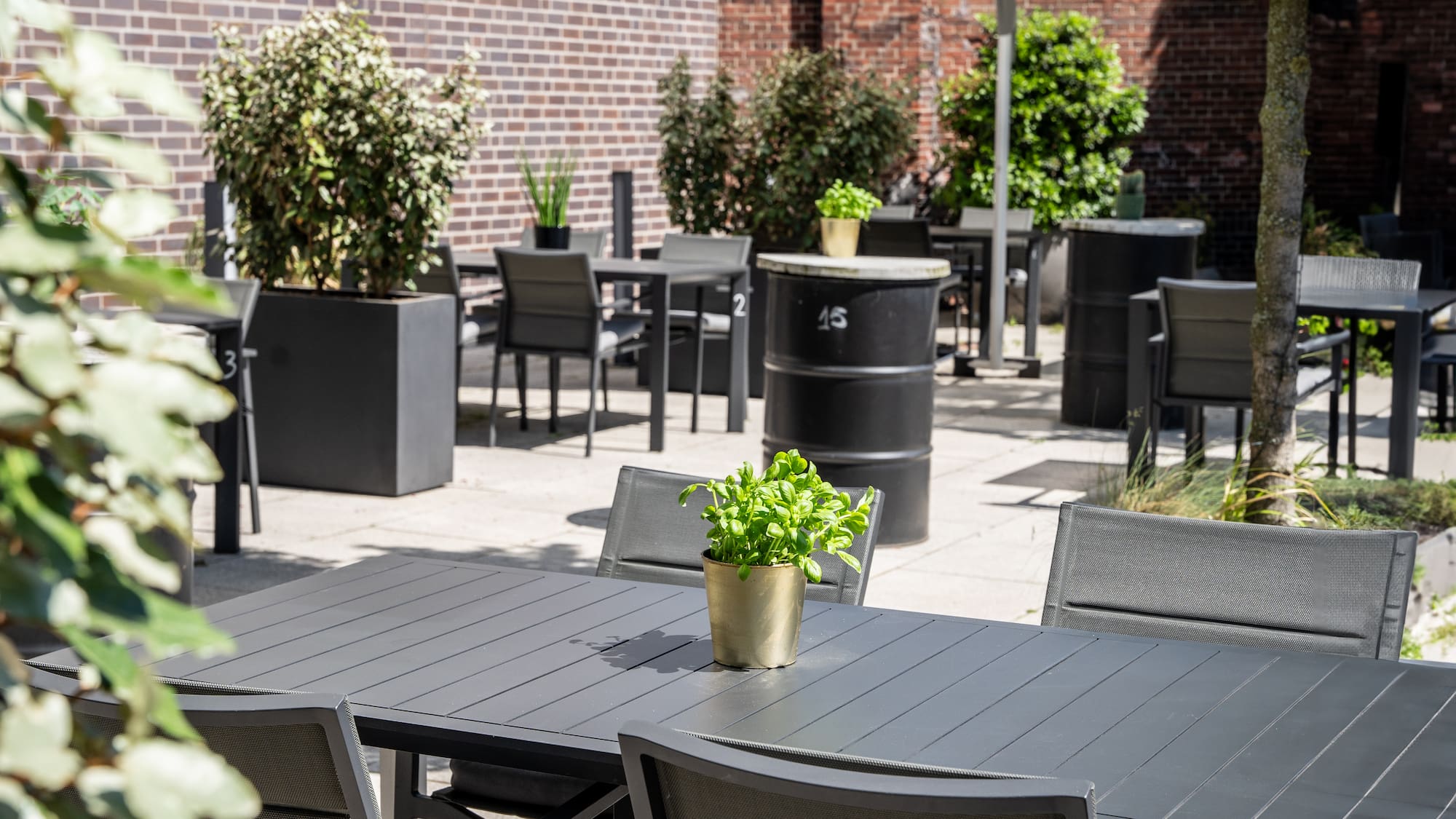 a table and chairs outside with a brick wall and a brick wall