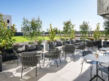 a patio with chairs and tables