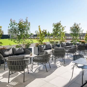 a patio with chairs and tables