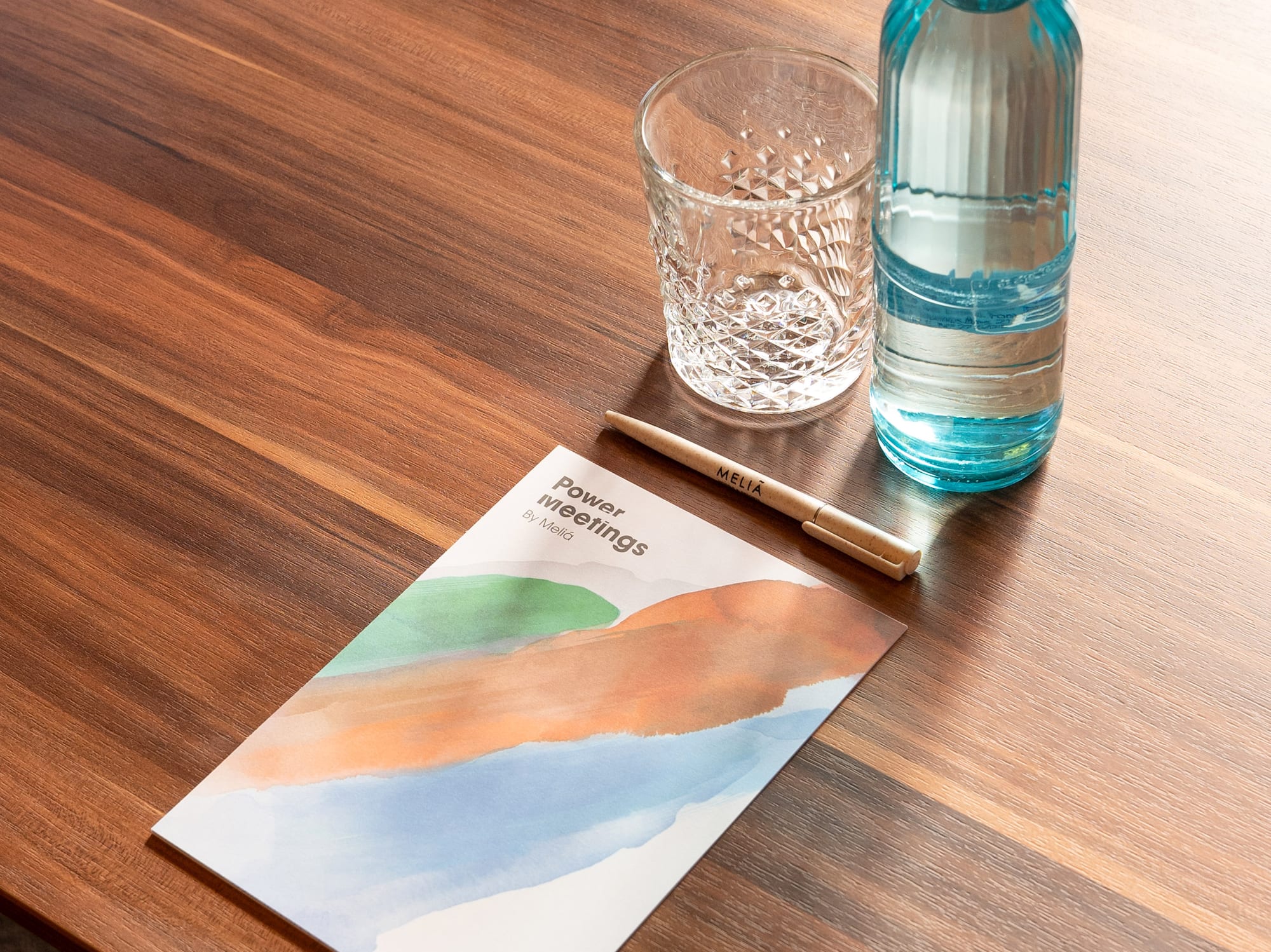 a water bottle and a pen on a table