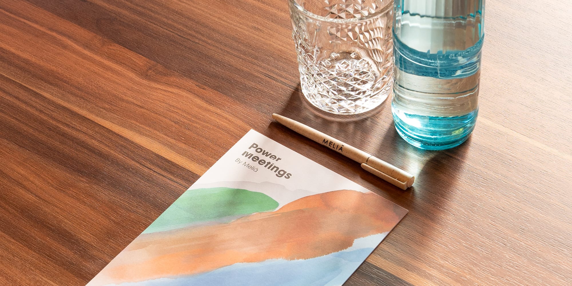 a water bottle and a pen on a table