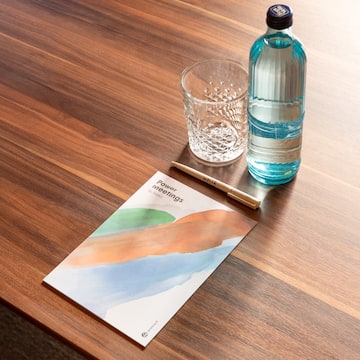 a water bottle and a pen on a table