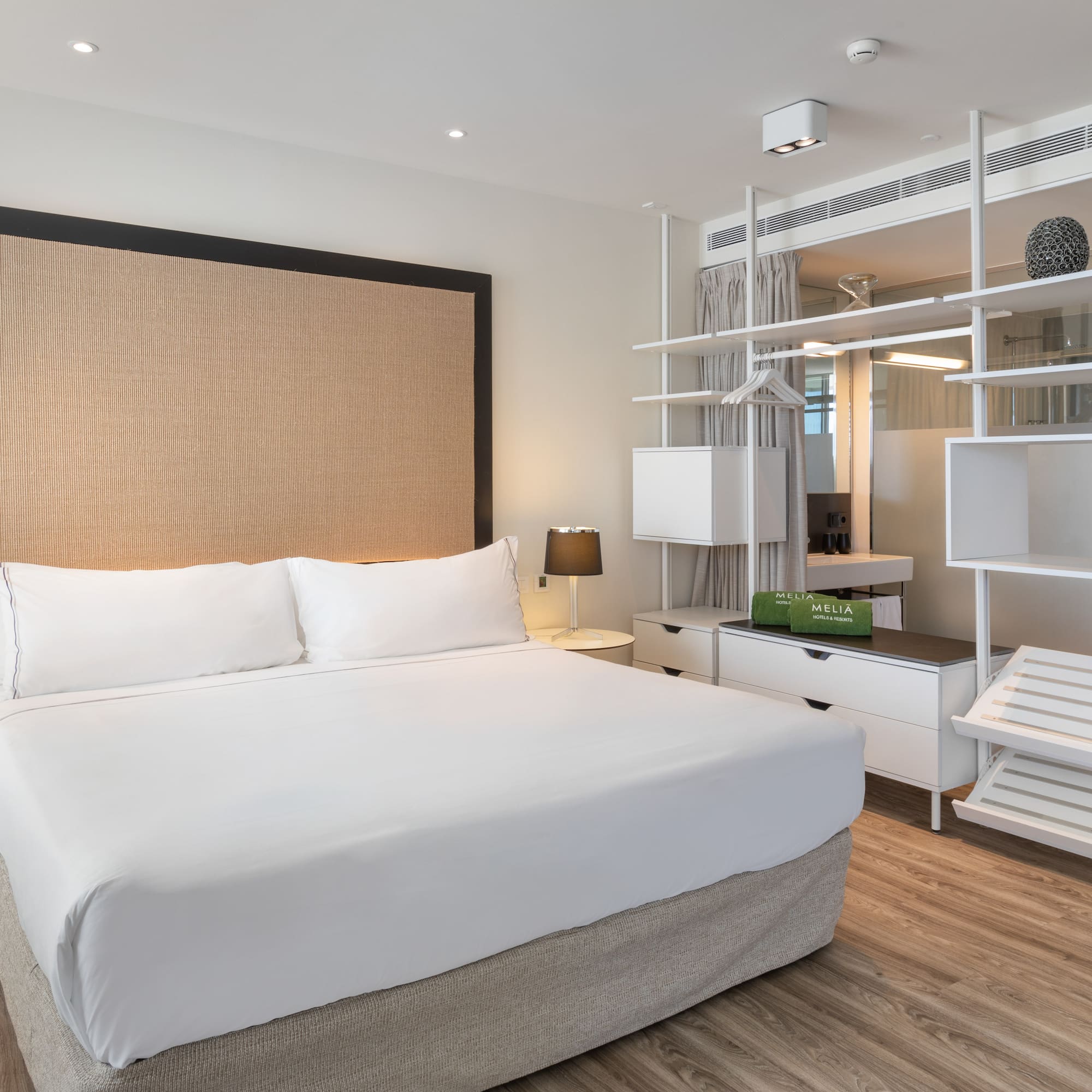 a room with a bed and a shelf