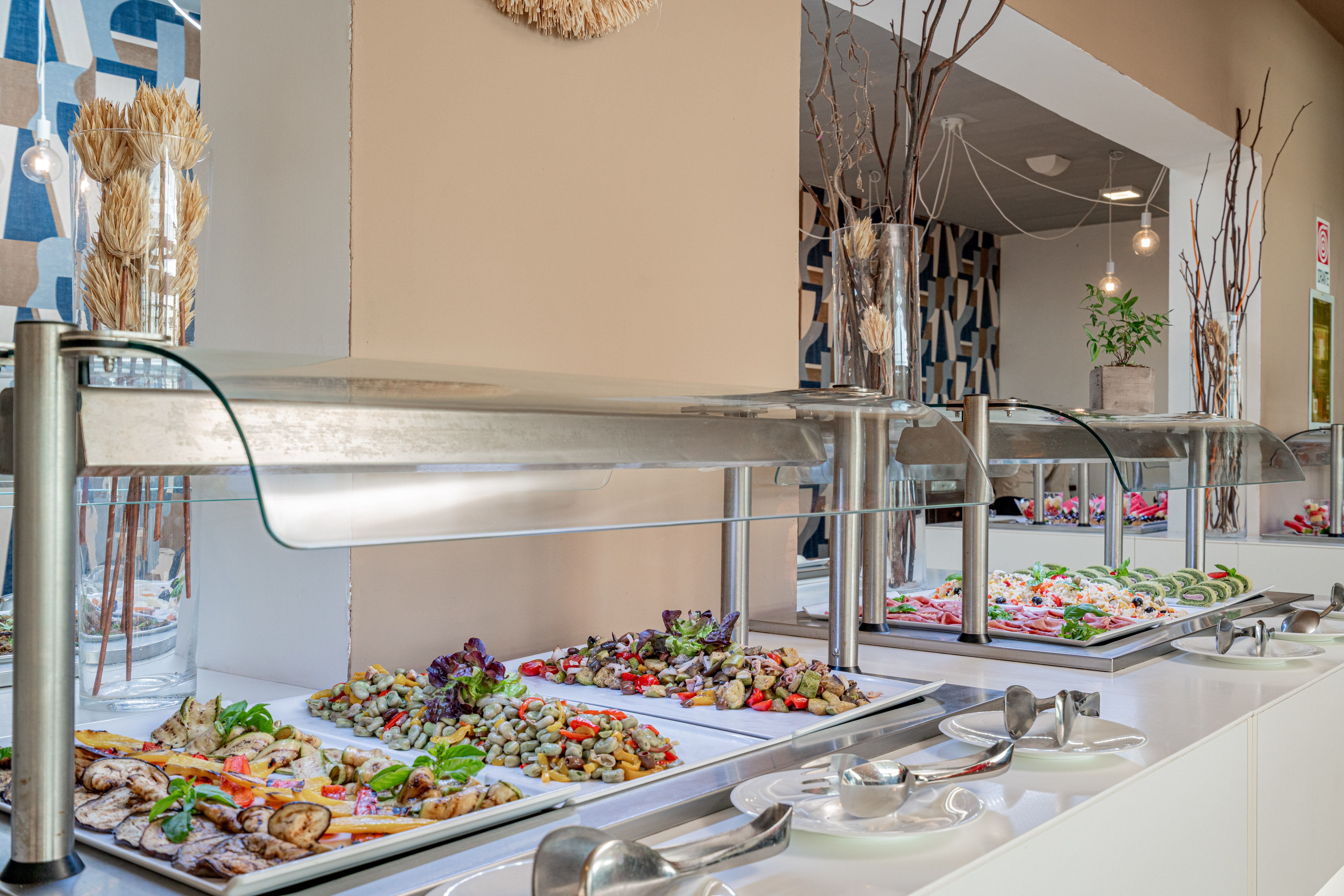 Healthy buffet spread with fresh salads, grilled vegetables, and cold dishes.