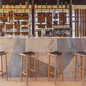 a bar with stools in front of a counter