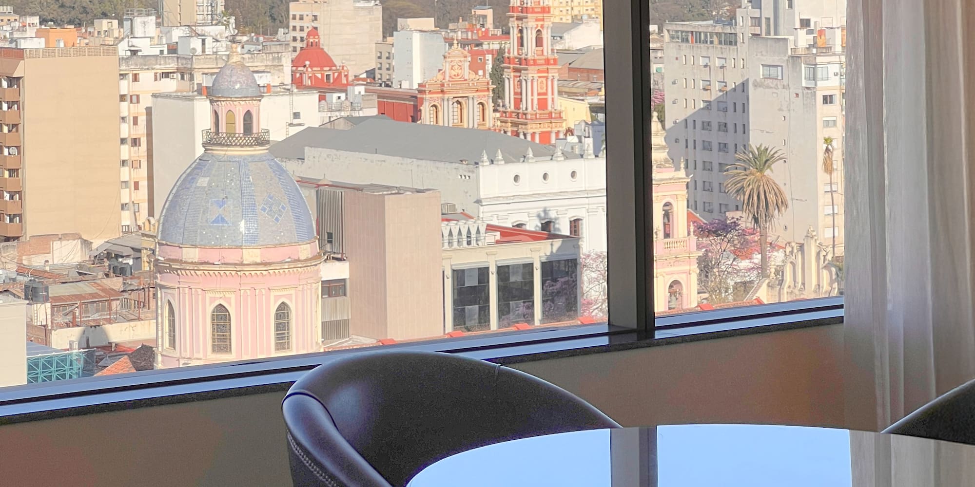 a room with a table and chairs and a view of a city