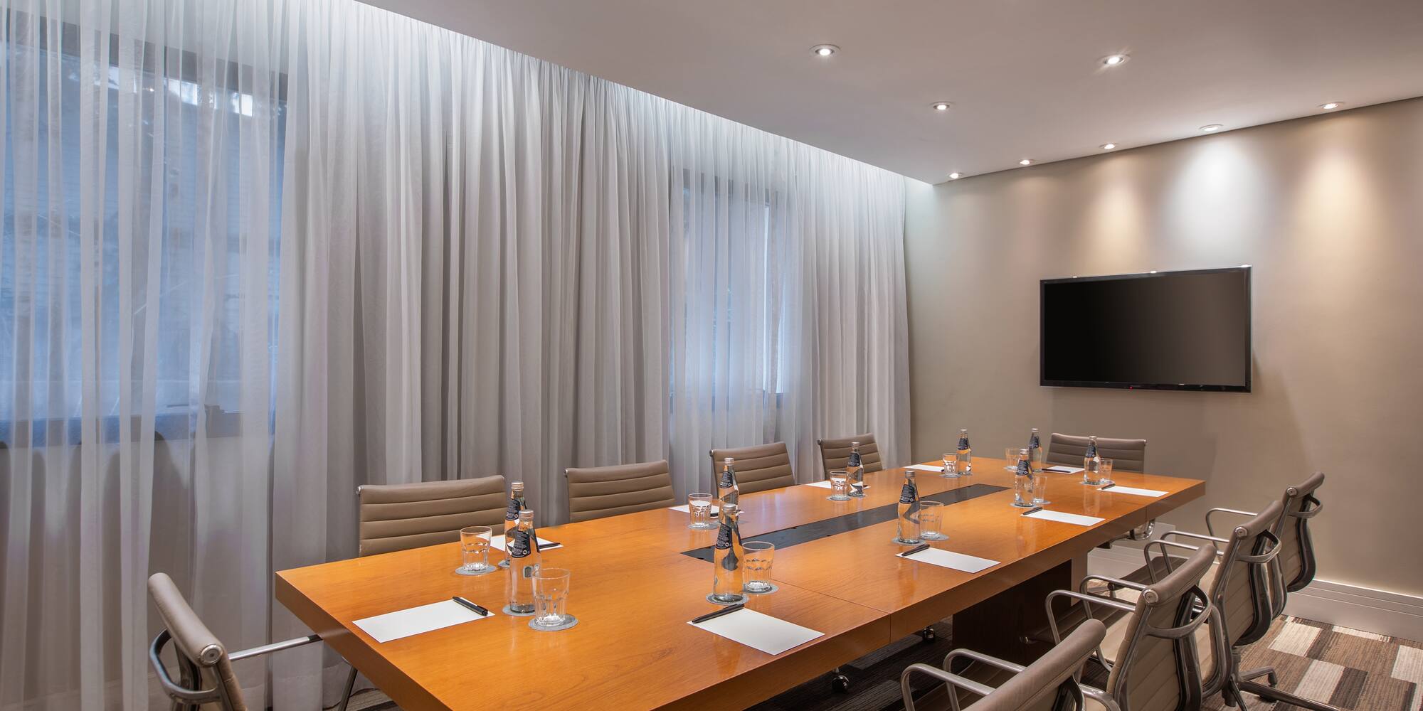 a conference room with a table and chairs