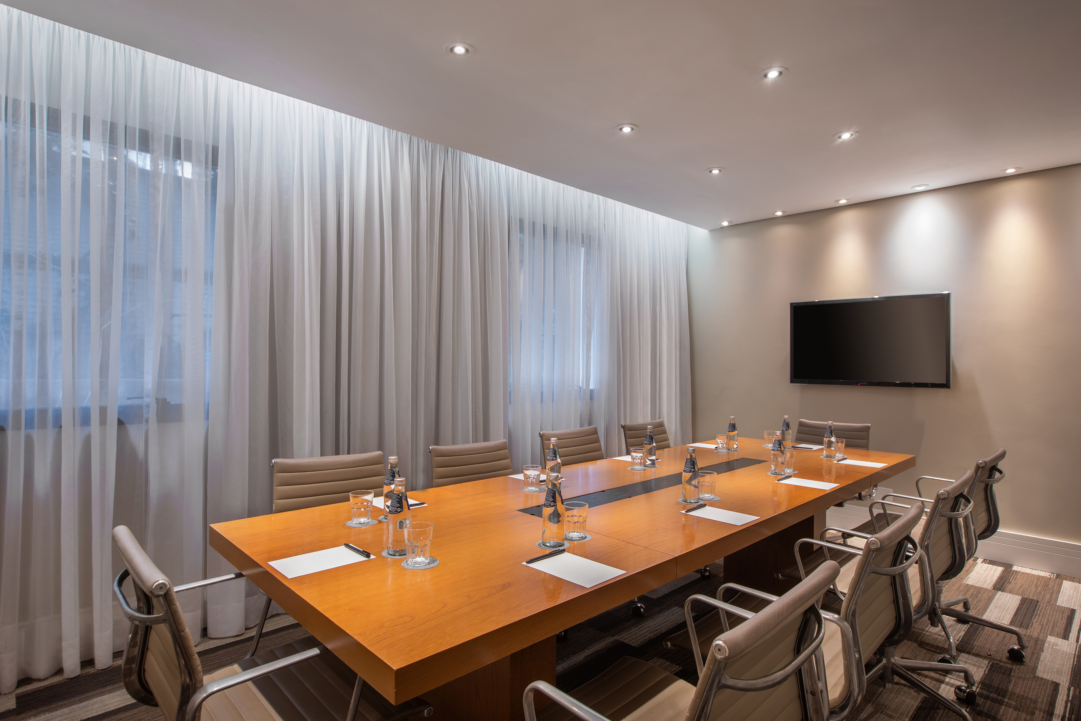 a conference room with a table and chairs