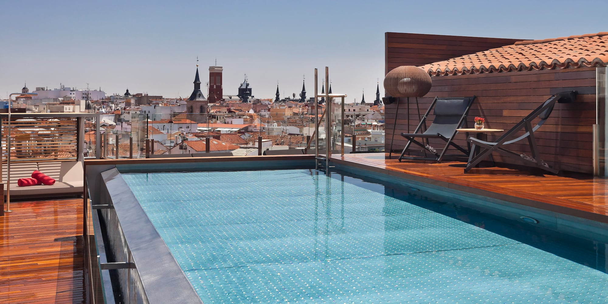 a pool on a roof with a city in the background