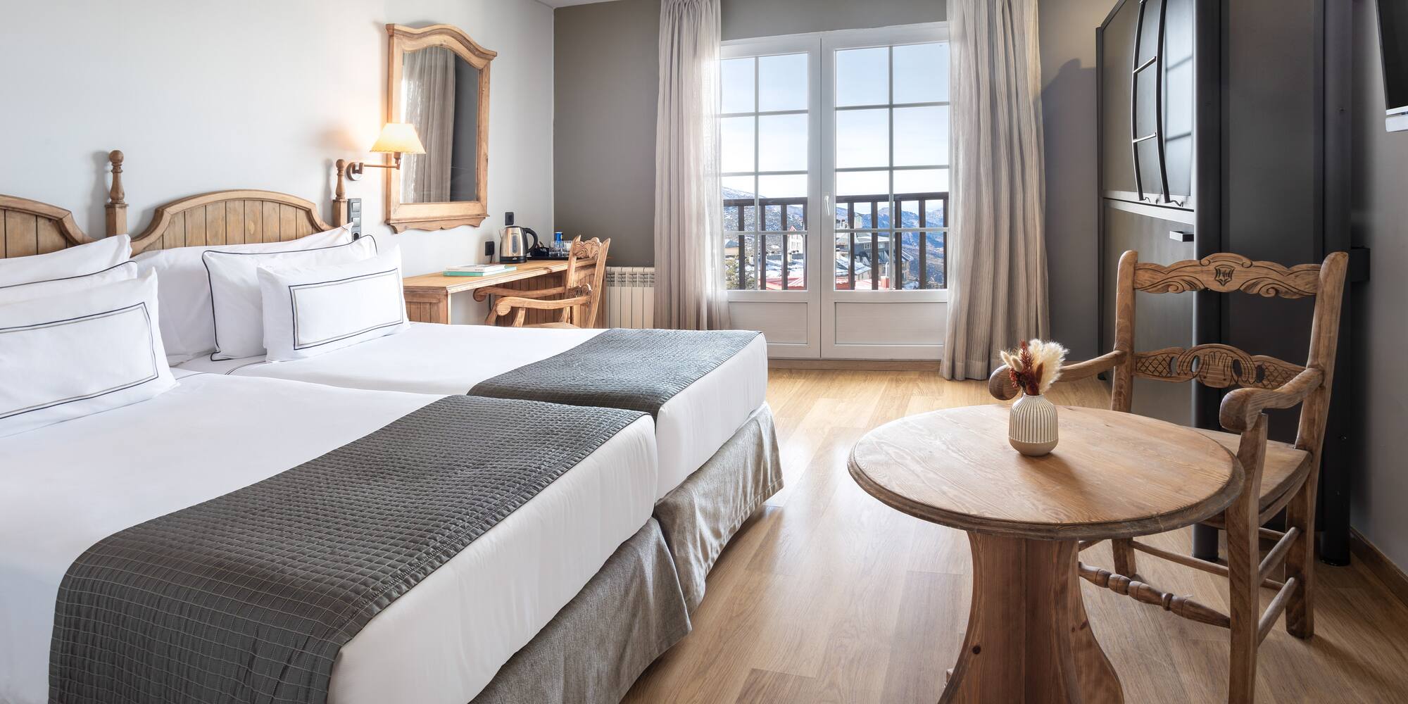 a room with two beds and a table