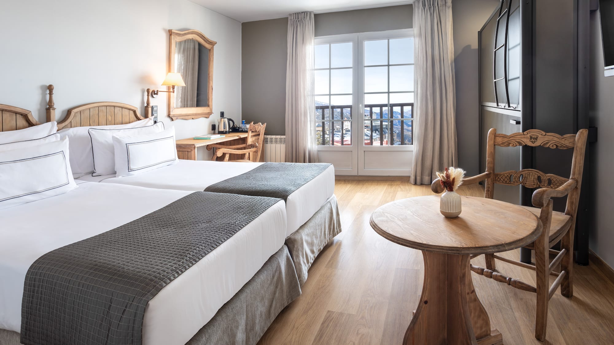 a room with two beds and a table