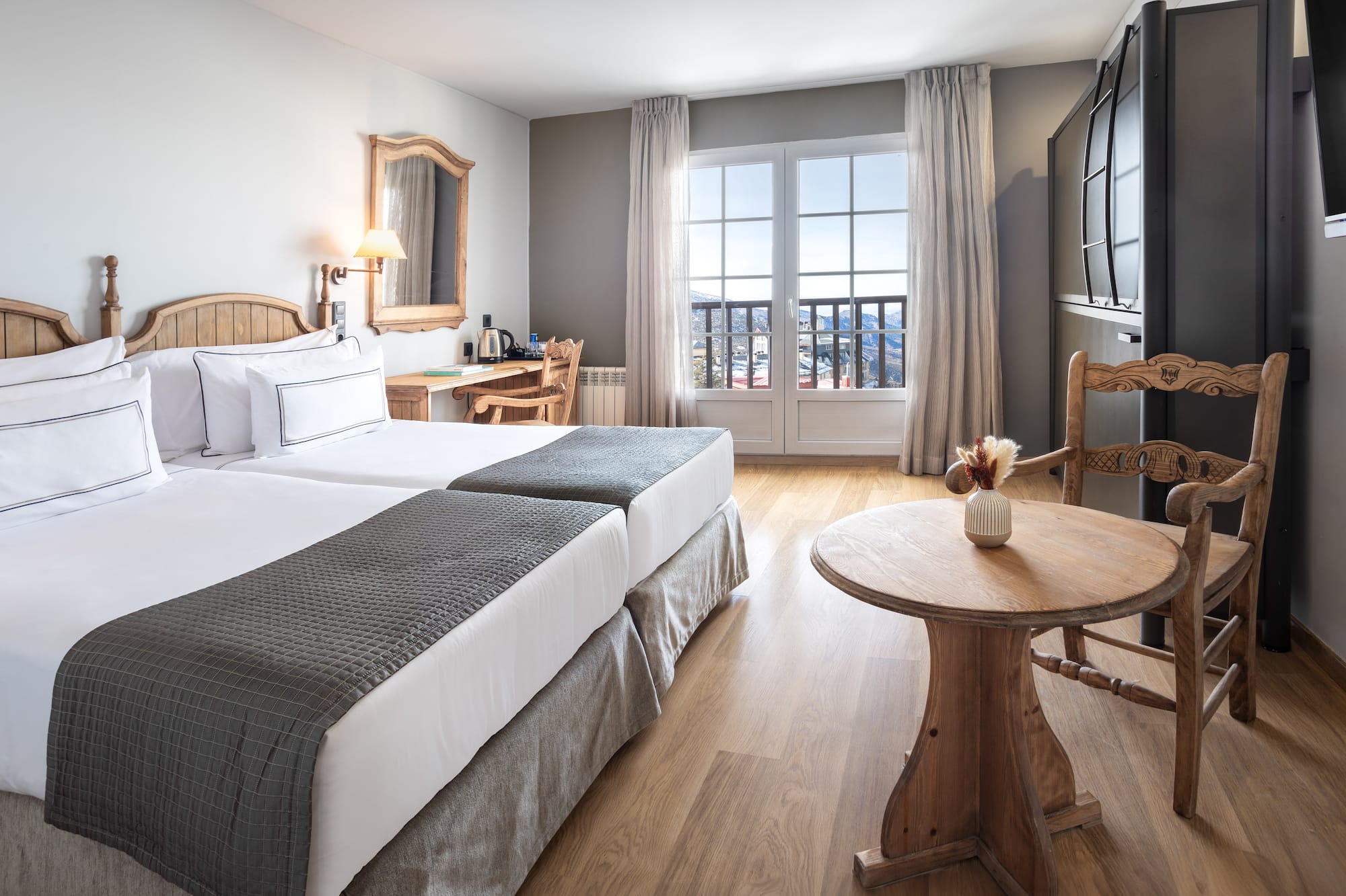 a room with two beds and a table