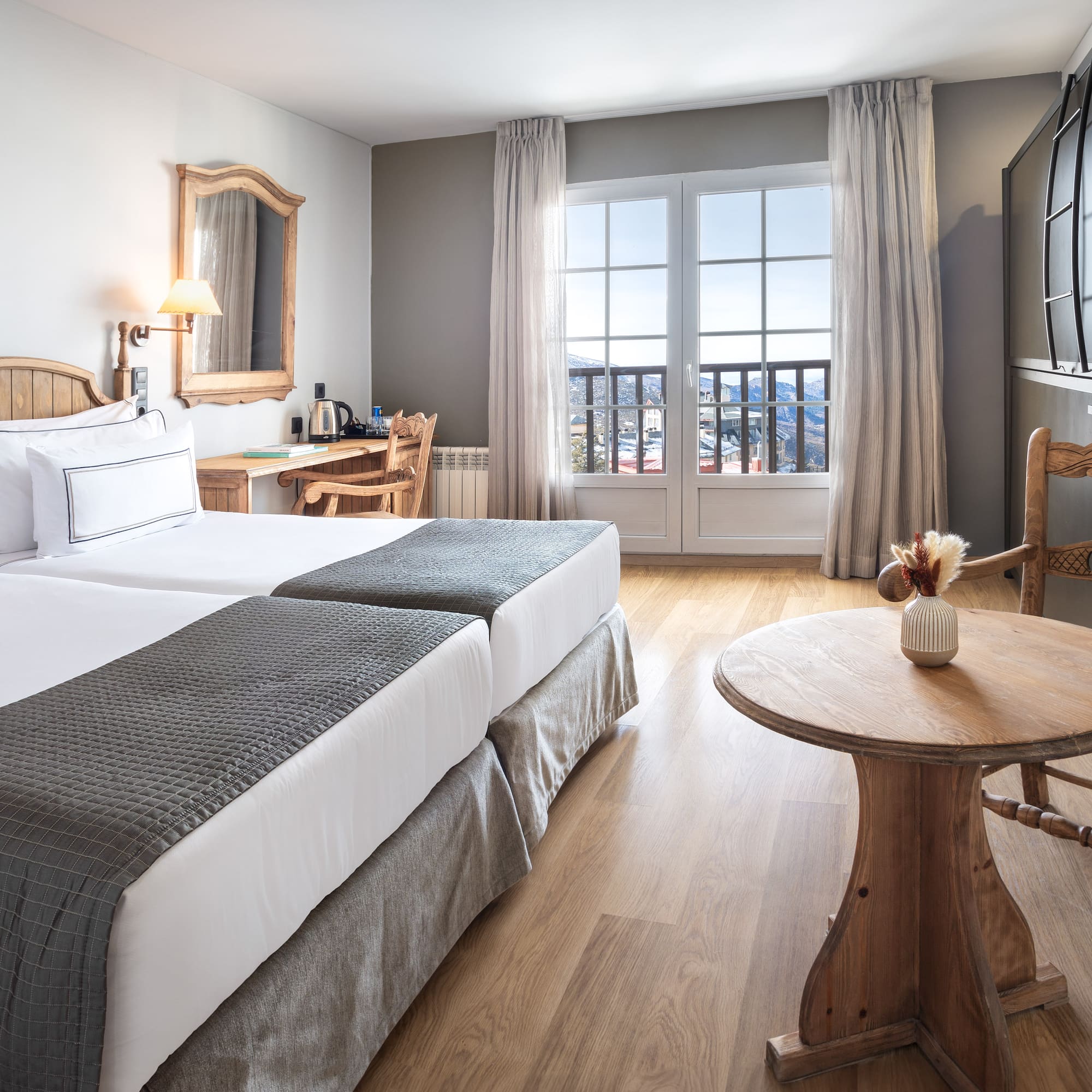 a room with two beds and a table