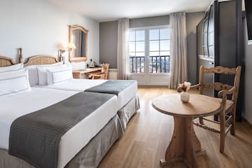 a room with two beds and a table