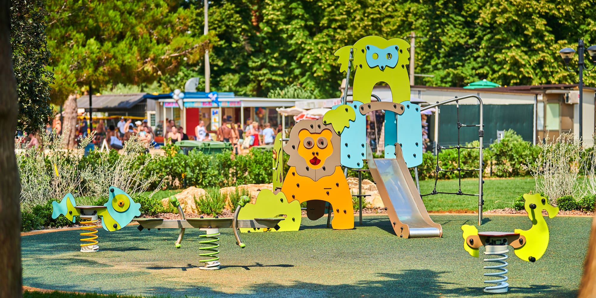 a playground with a slide and a slide in the middle of a park