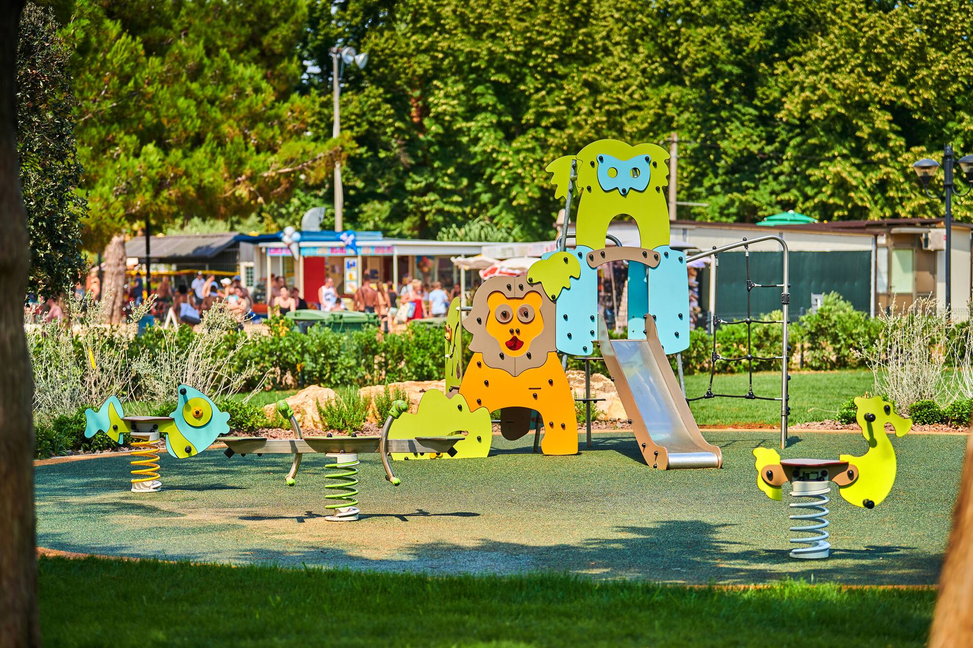 a playground with a slide and a slide in the middle of a park