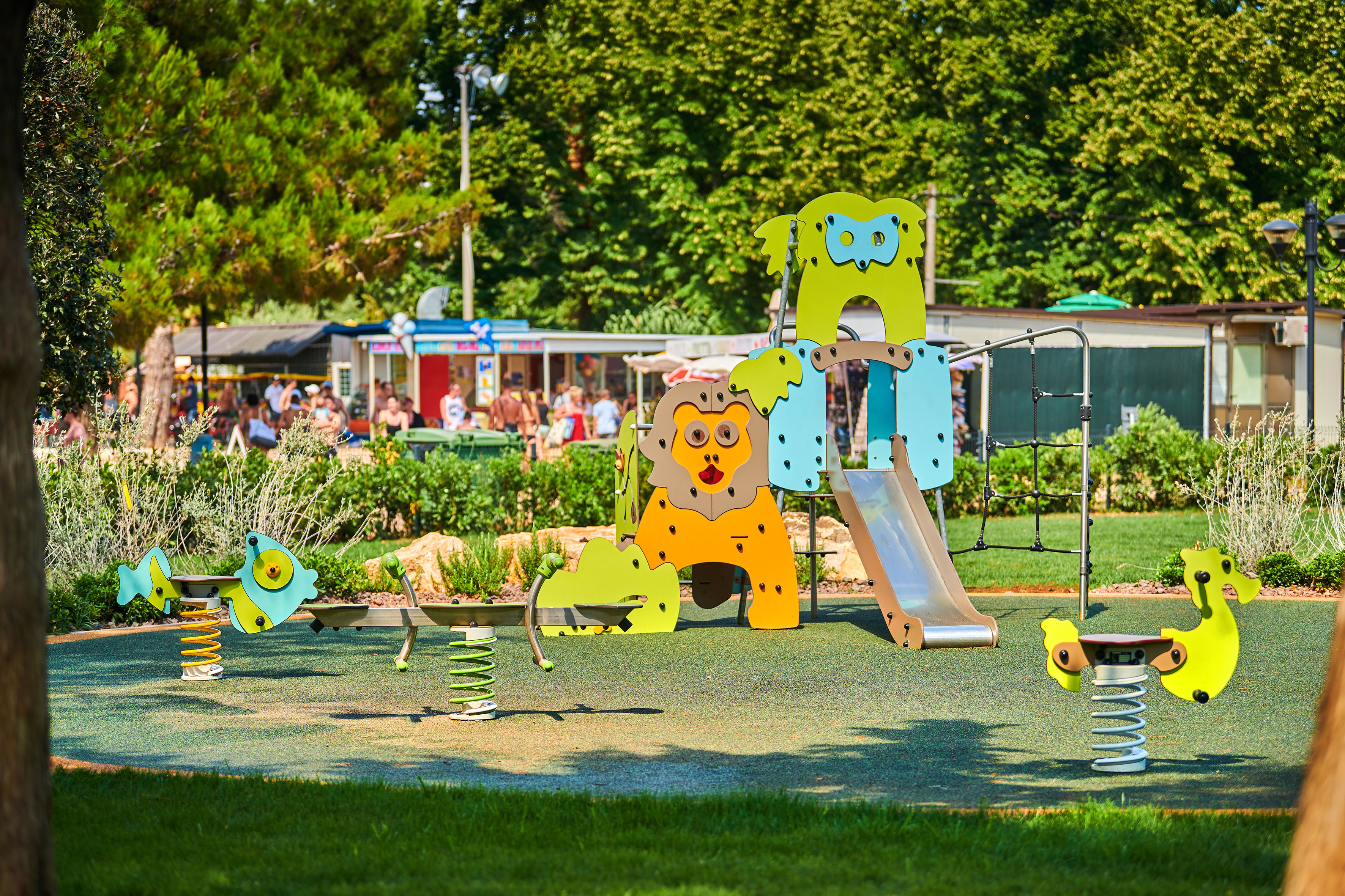 a playground with a slide and a slide in the middle of a park