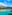 a body of water with a city and mountains in the background