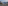 Snowy mountain resort with buildings, evergreen trees, and majestic peaks.