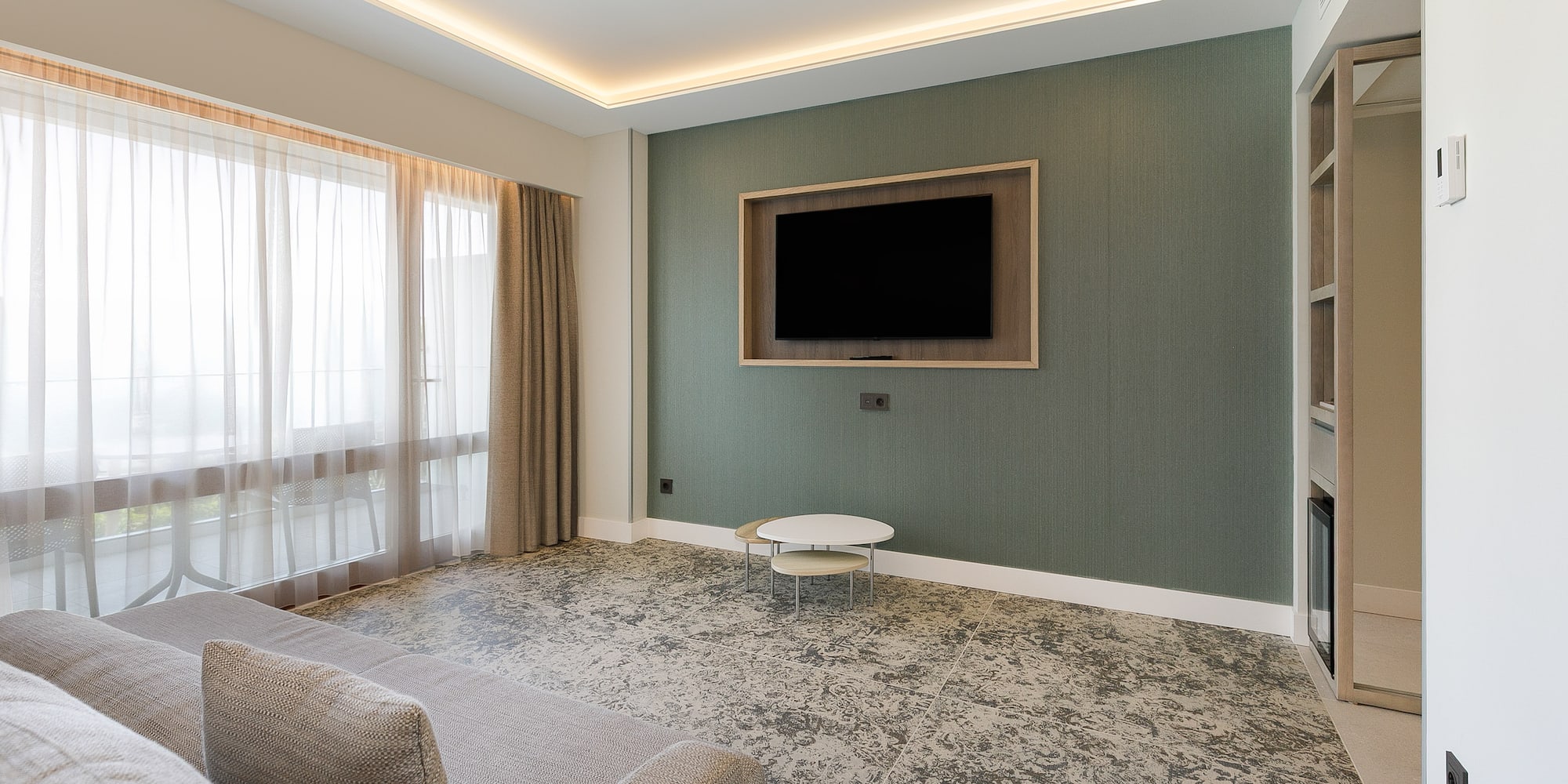 a living room with a tv on the wall