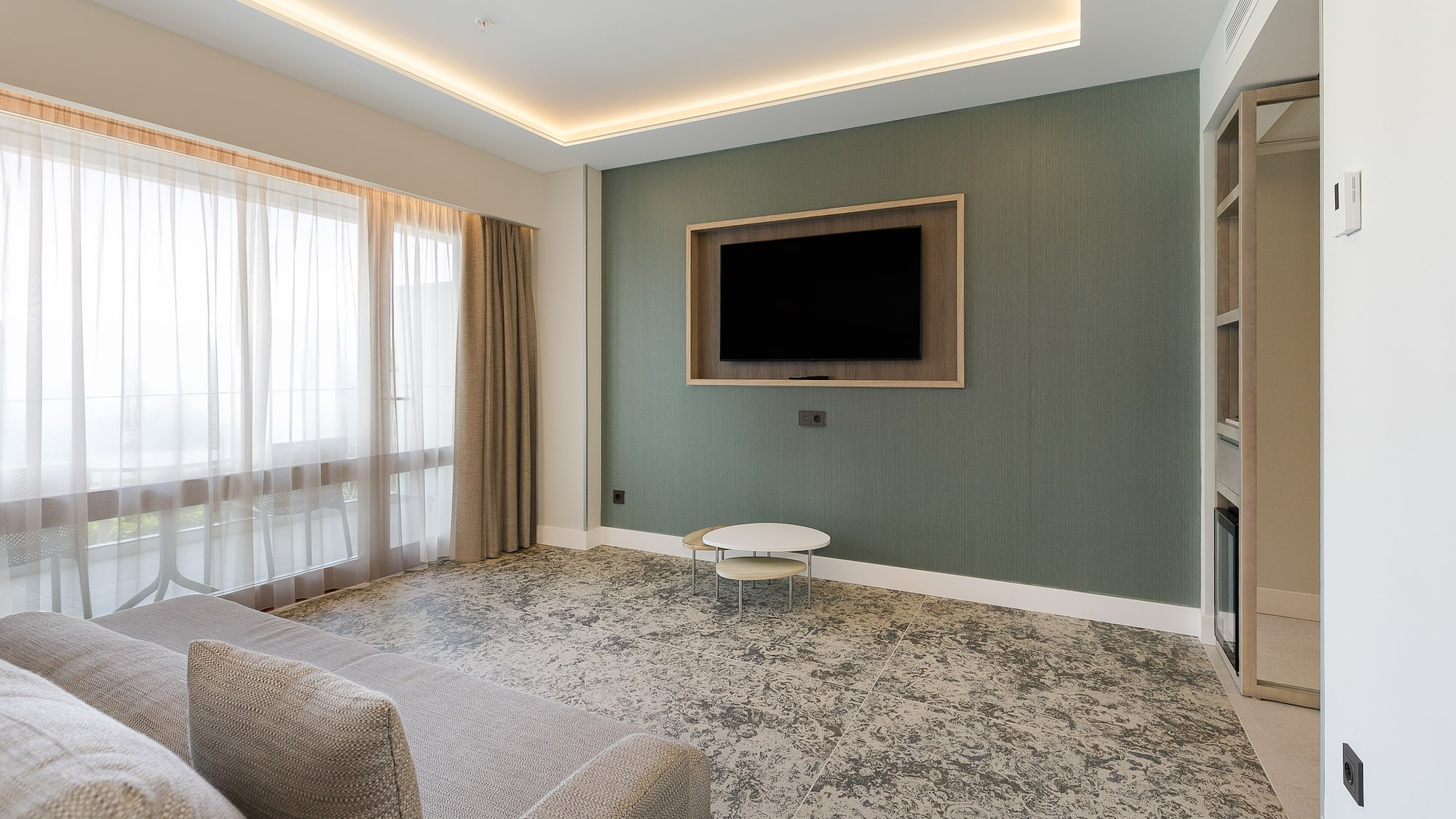 a living room with a tv on the wall