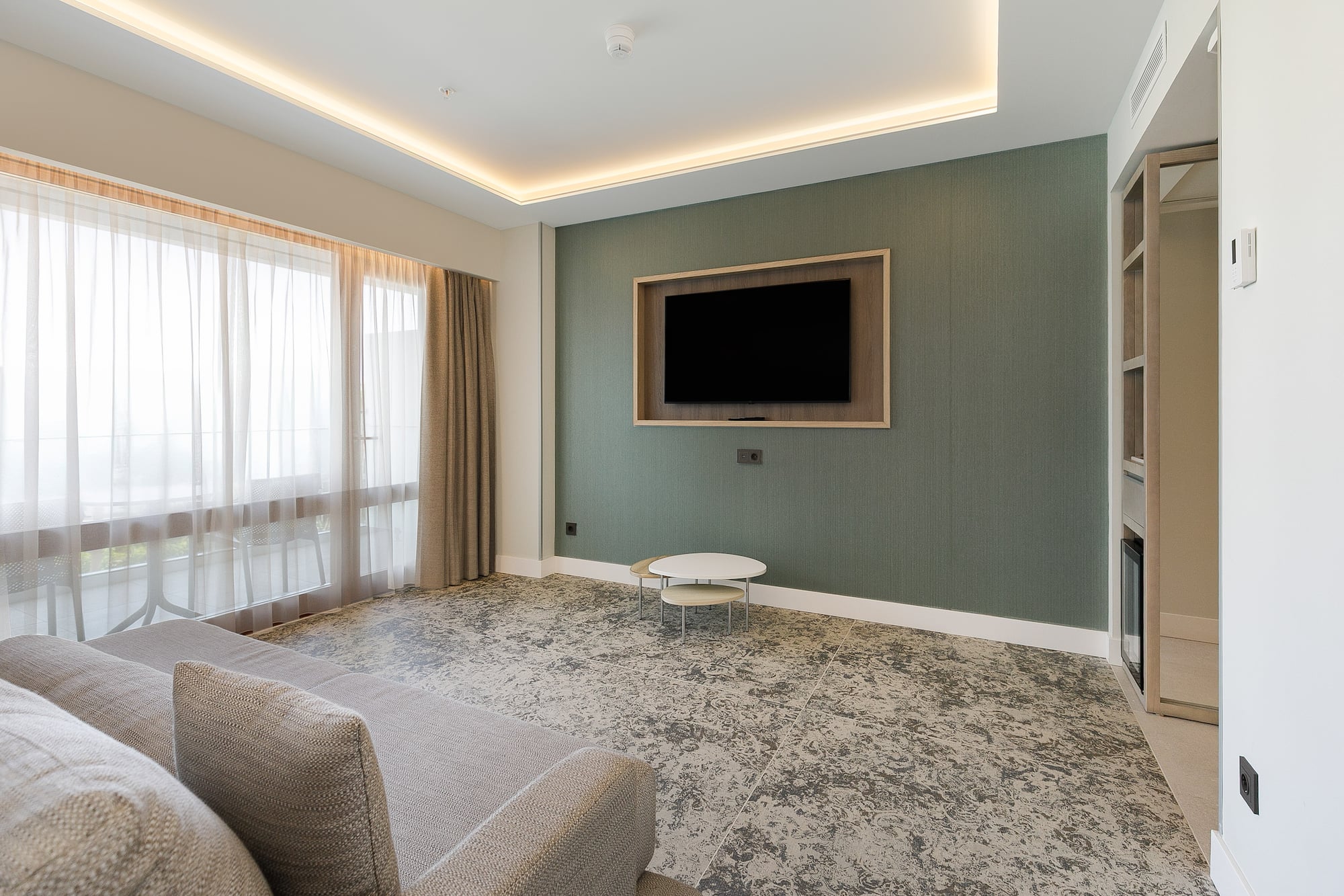 a living room with a tv on the wall