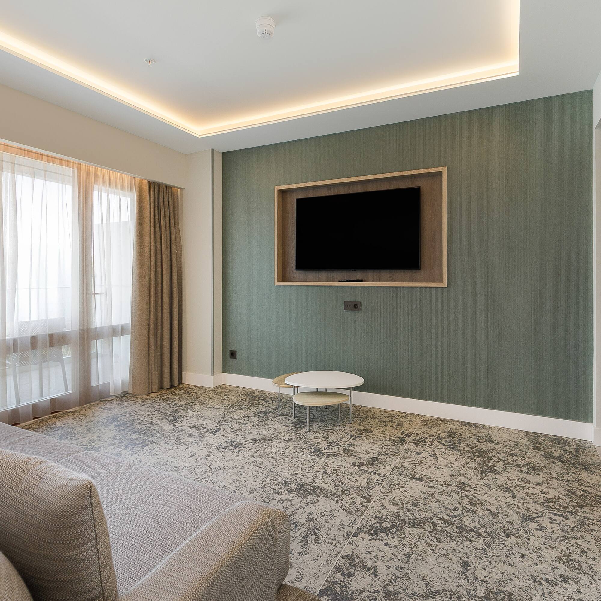 a living room with a tv on the wall