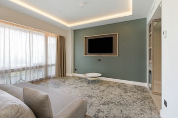 a living room with a tv on the wall