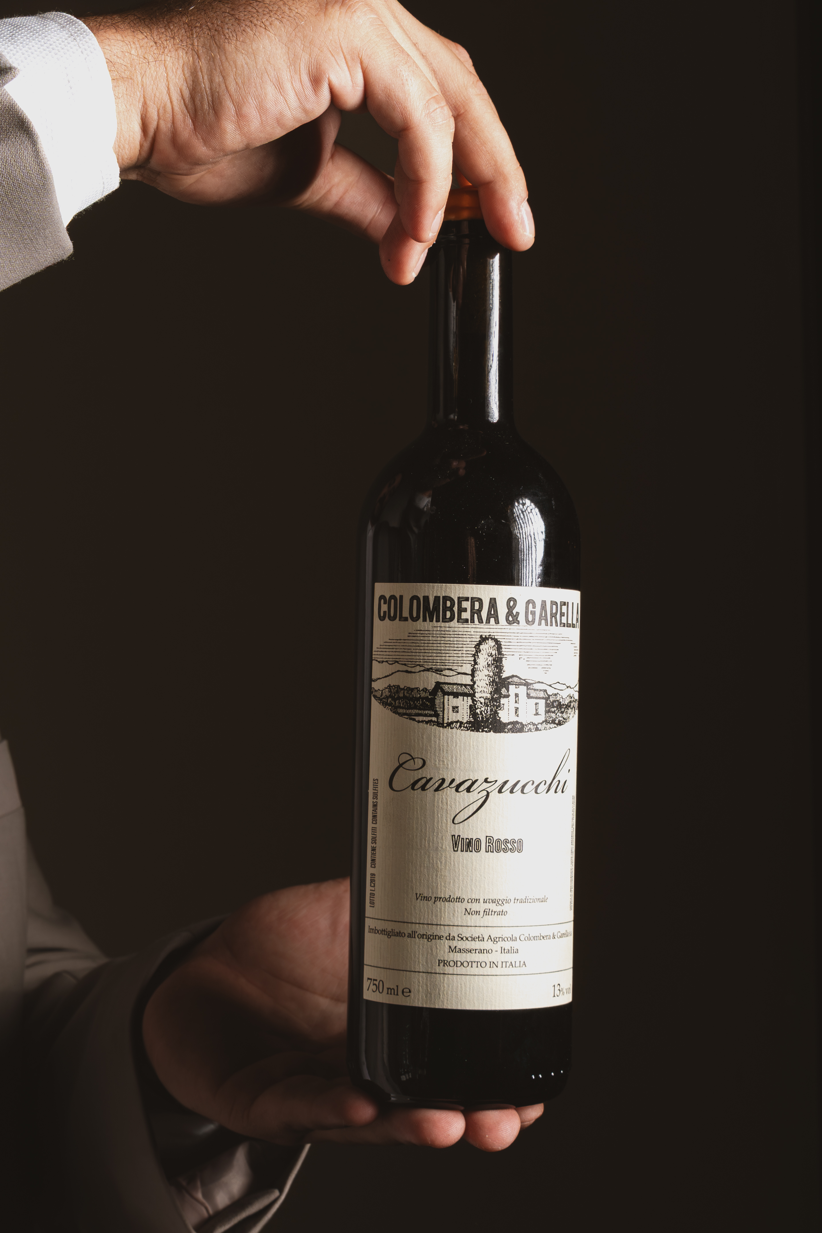 a person holding a bottle of wine